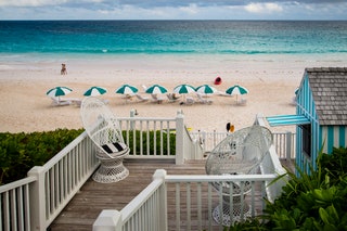 String of striped beach umbrellas Harbour Island